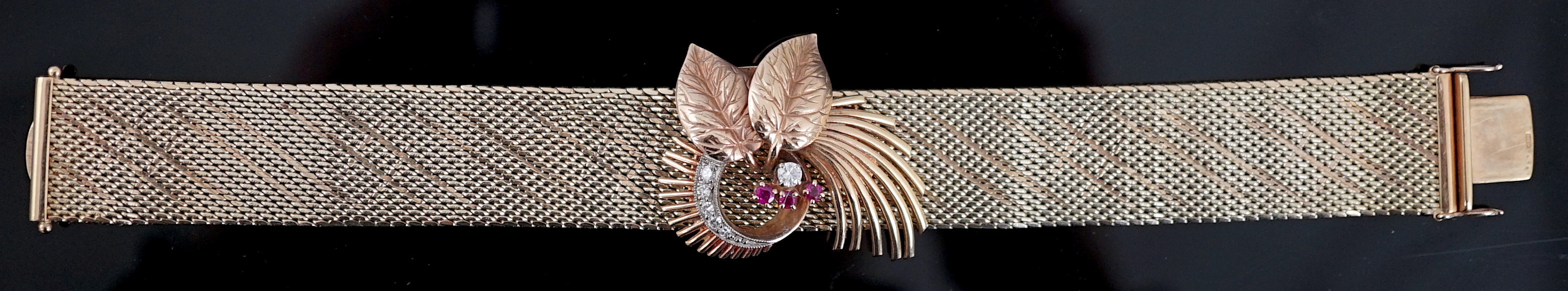 A 1960's 9ct gold ruby and diamond cluster set bracelet, with detachable central foliate scroll clip brooch
